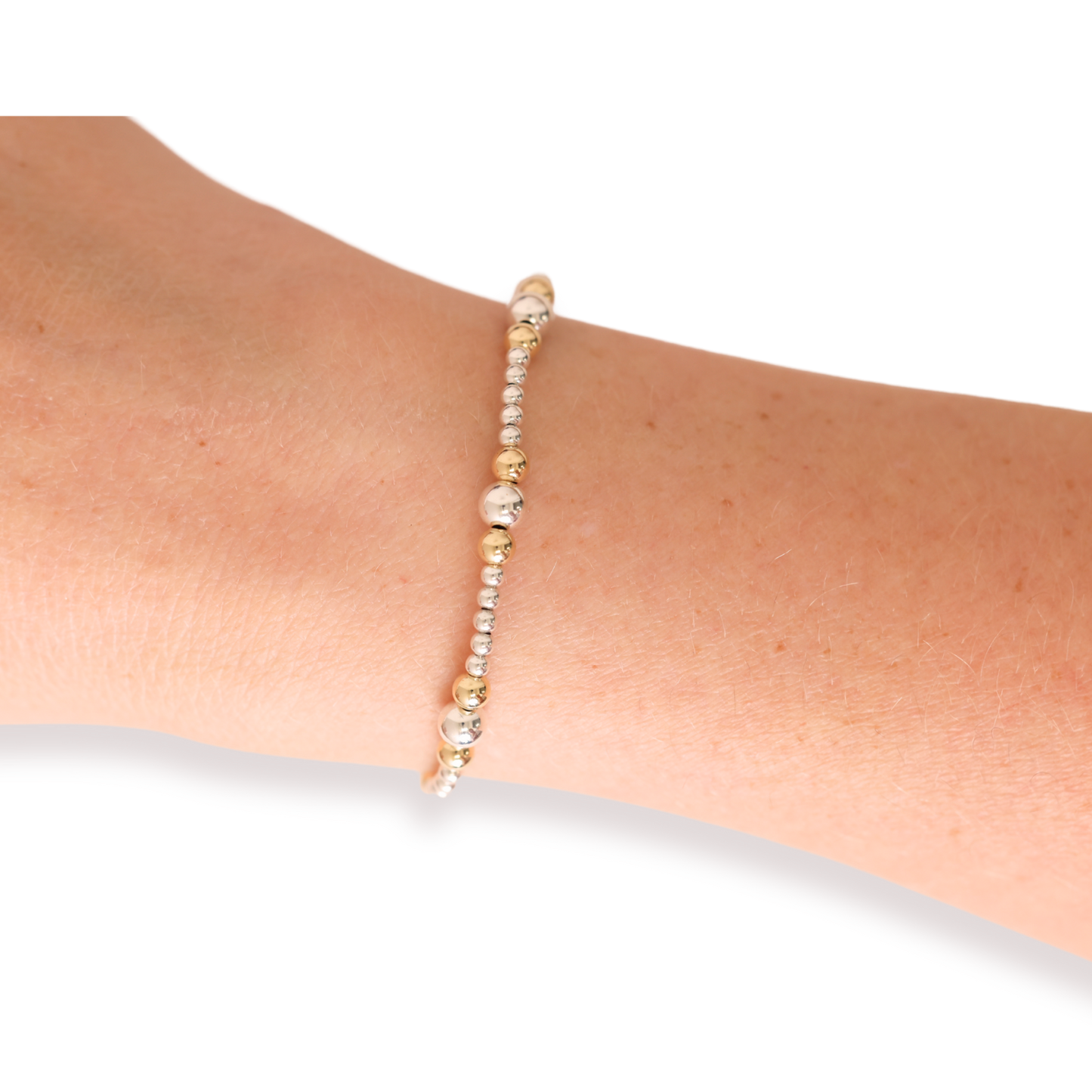 Beaded bracelet on a wrist with a plain background