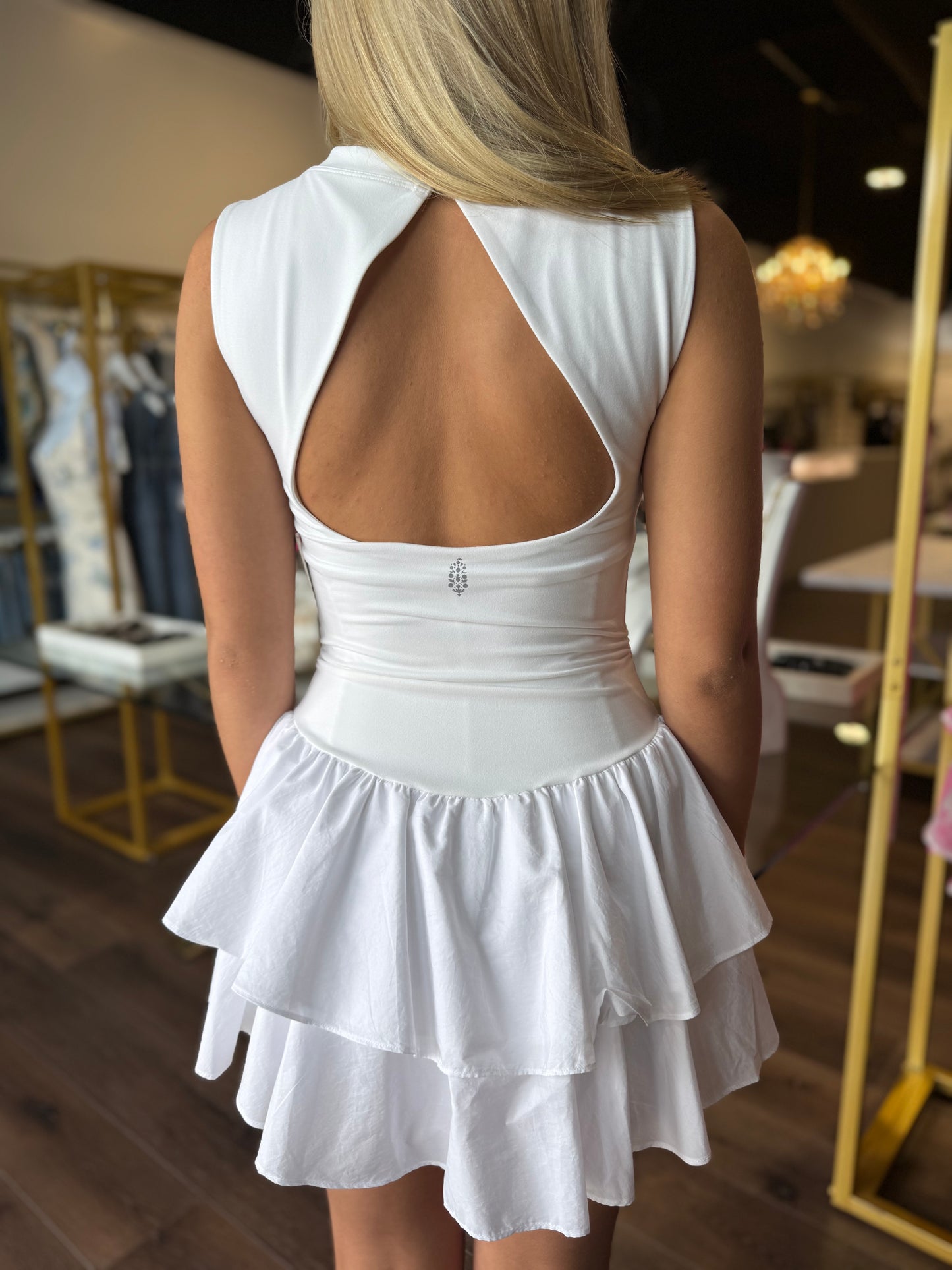 Britique Boutique model wearing white Free People Field Day Skortsie showing back of romper dress