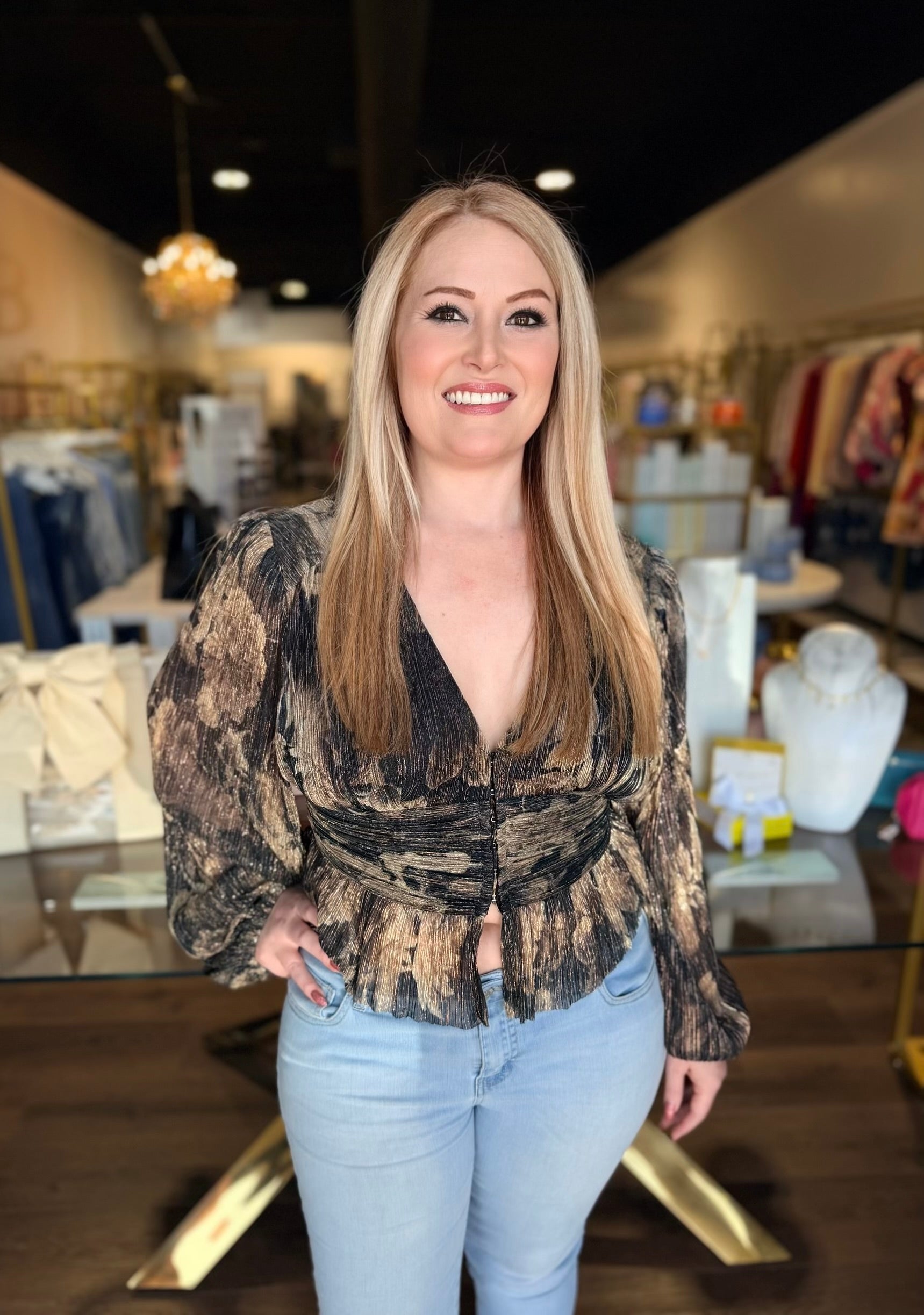 Model in black blouse top in front of the store 
