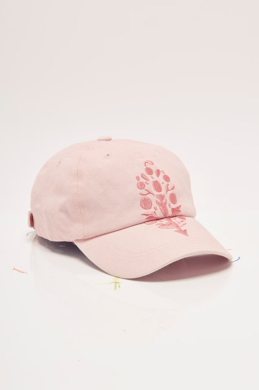 Pink baseball cap with floral embroidery on a light gray background