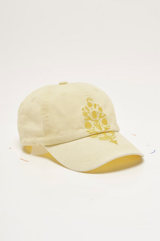 Beige cap with yellow floral embroidery on a white background