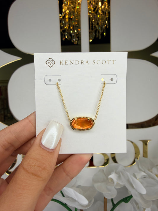 Gold Kendra Scott necklace with orange pendant