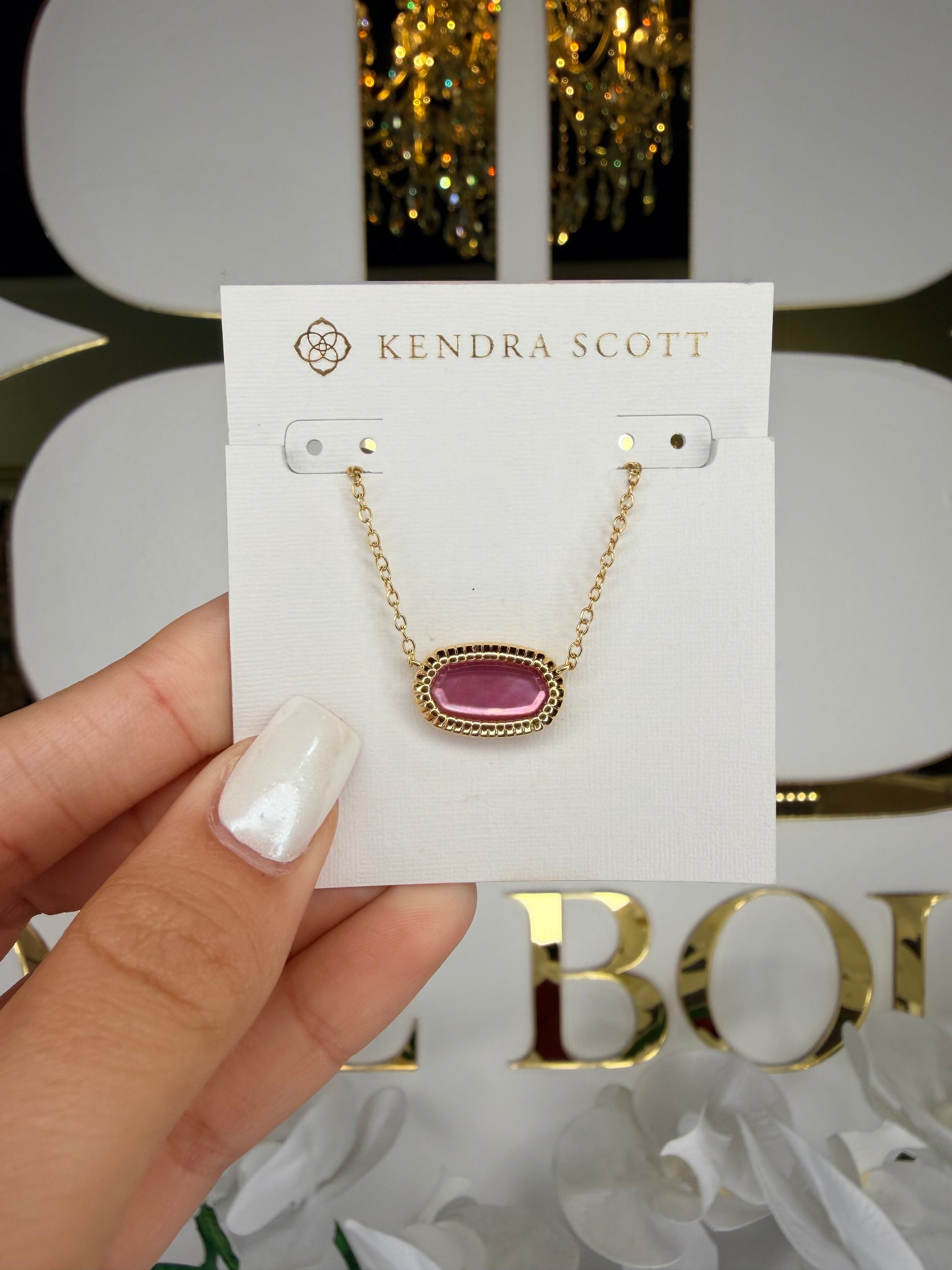 Gold Kendra Scott necklace with pink pendant