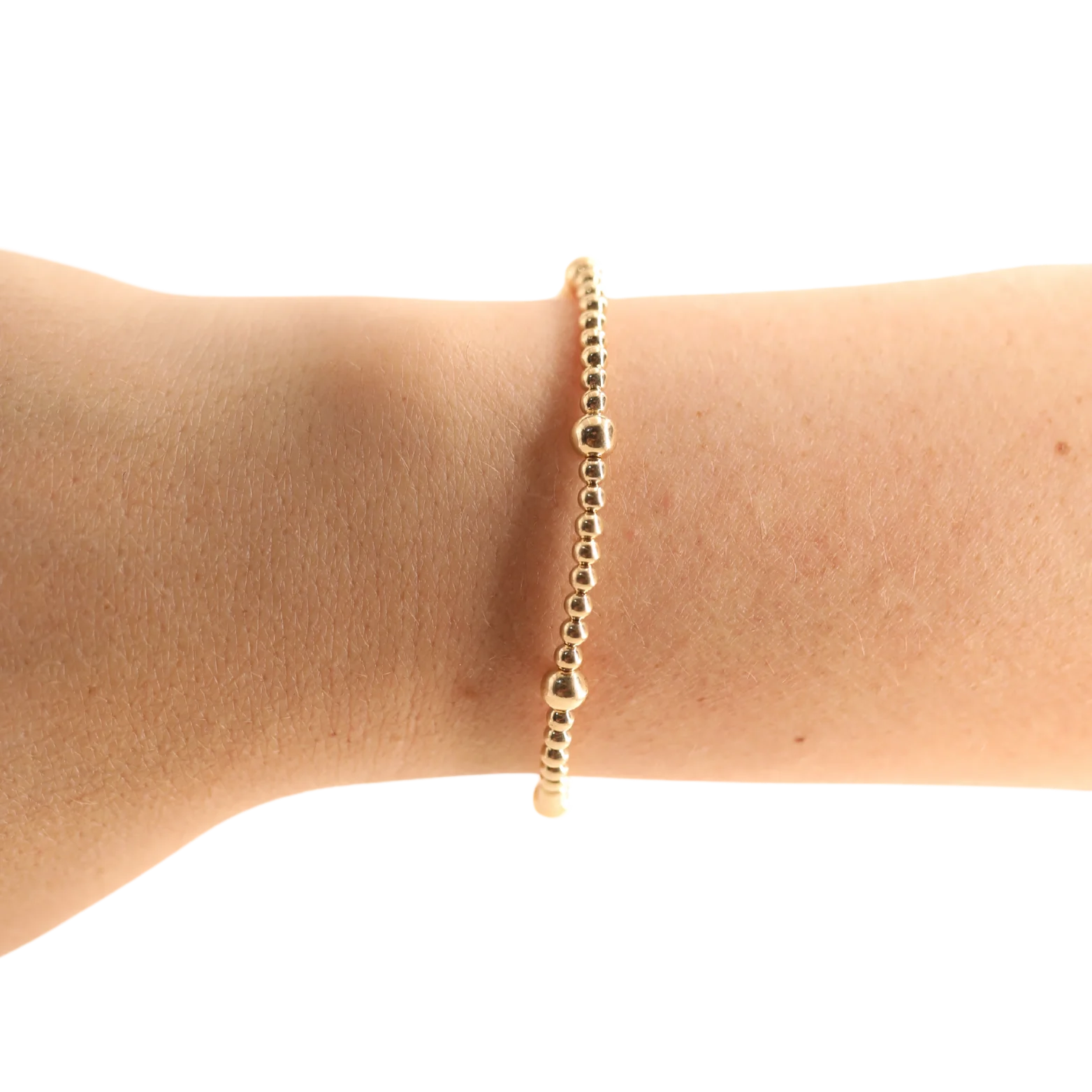 BOUTIQUE BEADED BLONDED GOLD OLIVE BRACELET ON ARM