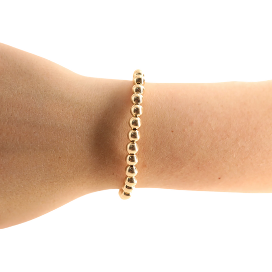 BOUTIQUE BEADED BLONDES 6MM GOLD BRACELET ON ARM