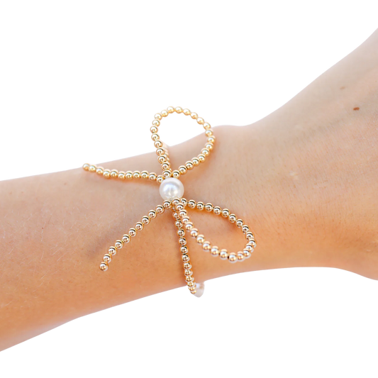 BOUTIQUE BEADED BLONDES GOLD BOW BRACELET ON ARM
