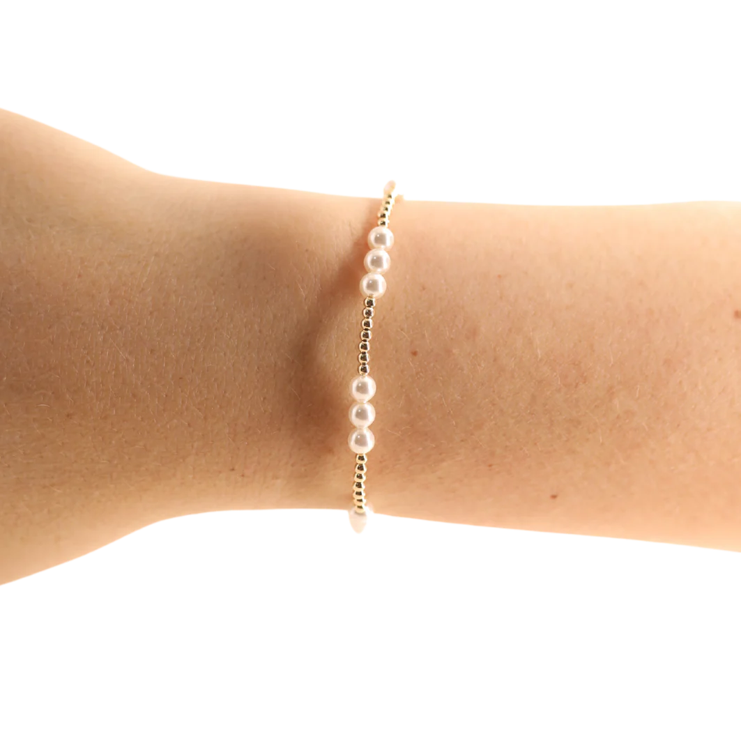 BOUTIQUE BEADED BLONDES GOLD WITH PEARLS ILY BRACELET ON ARM 