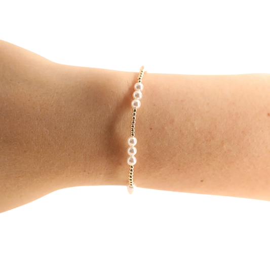 BOUTIQUE BEADED BLONDES GOLD WITH PEARLS ILY BRACELET ON ARM 