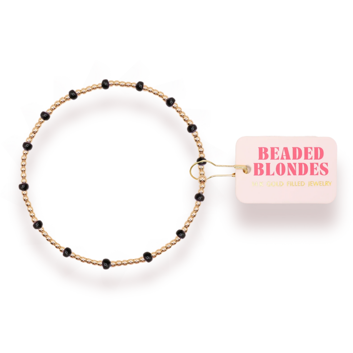 Beaded Blondes Black Dainty Poppi Bracelet shown beside its jewelry tag.