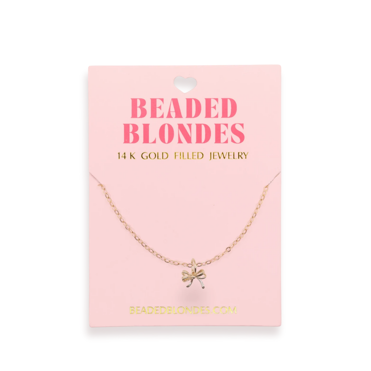Beaded Blondes Bow Charm Necklace displayed on a pink jewelry card.