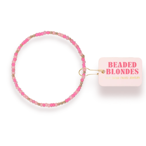 Beaded Blondes Flamingo Sprinkle Bracelet beside a pink jewelry tag.