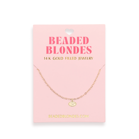 Beaded Blondes Georgia Logo Charm Necklace displayed on a pink jewelry card.