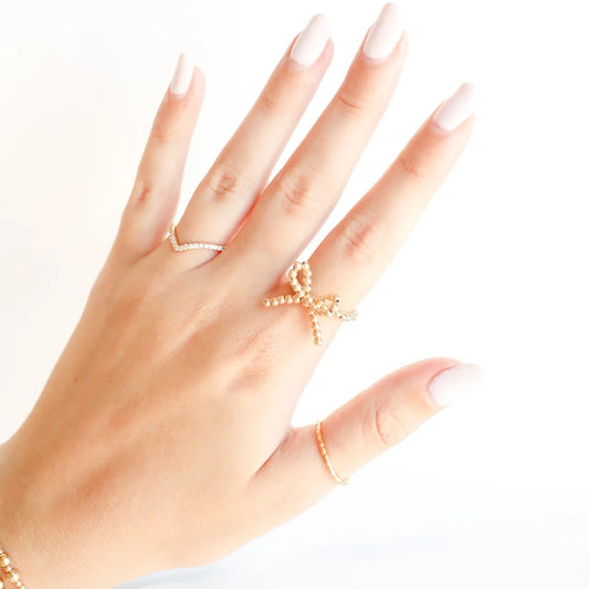 Beaded Blondes Gold Bow Ring worn on a hand.