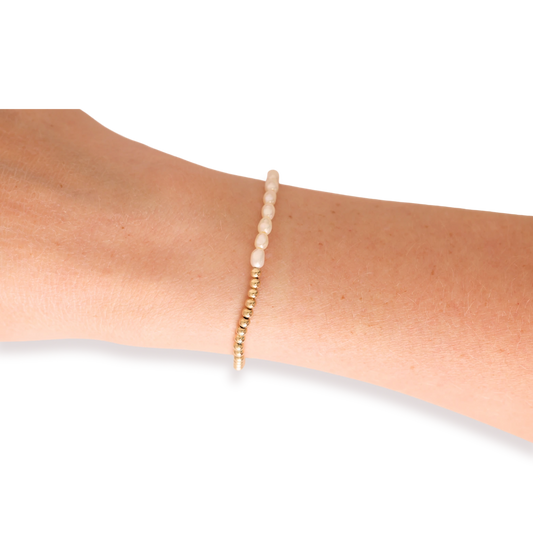 Beaded Blondes Hannah Pearl Bracelet in Gold worn alone on a wrist.