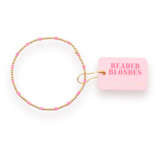 Hot Pink Dainty Poppi Bracelet arranged in a circle with a pink Beaded Blondes tag.