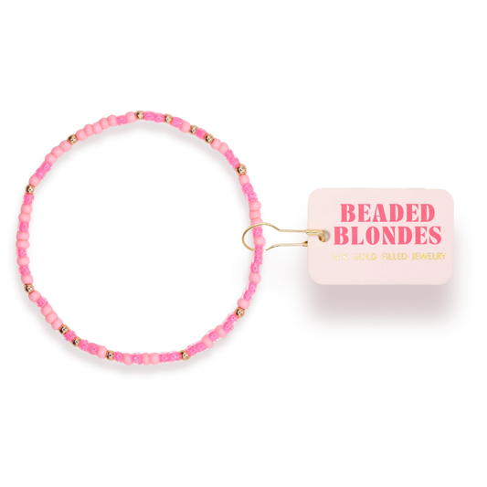 Beaded Blondes Hot Pink Sprinkle Bracelet beside a pink jewelry tag.