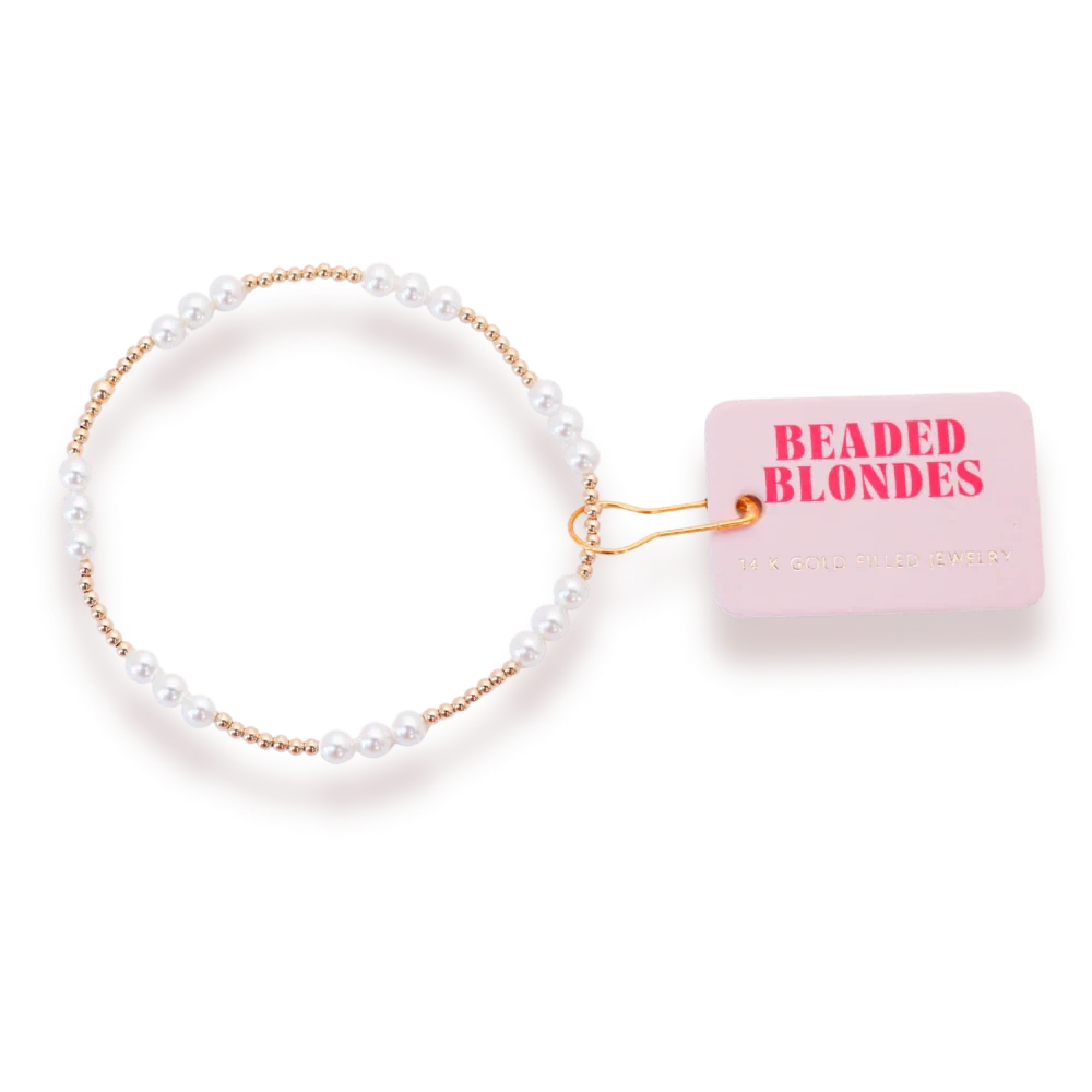 Beaded Blondes ILY Pearl Bracelet in Gold with a white pearl accent and small gold beads beside a brand tag.