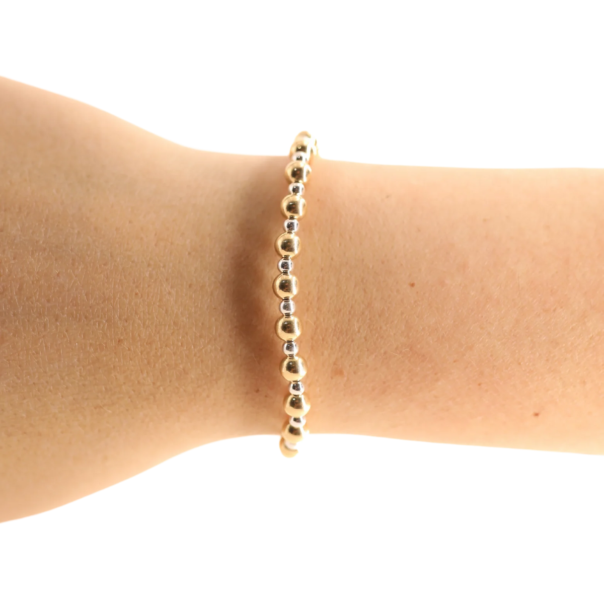 Gold and silver Katy beaded bracelet worn alone on a wrist against a white background.
