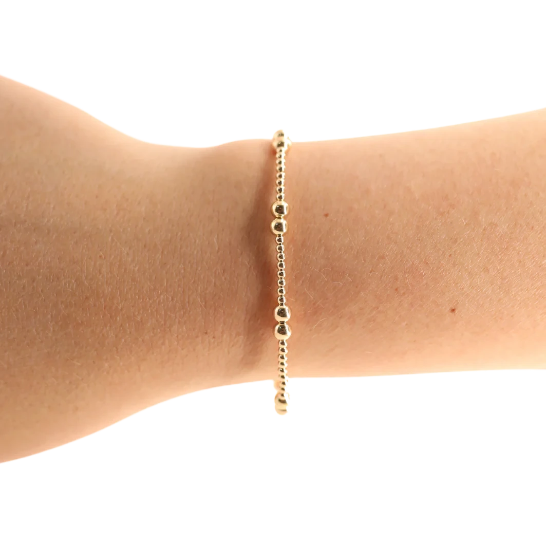 Beaded Blondes Leah Bracelet in Gold worn alone on a wrist, showing its small and larger gold beads.