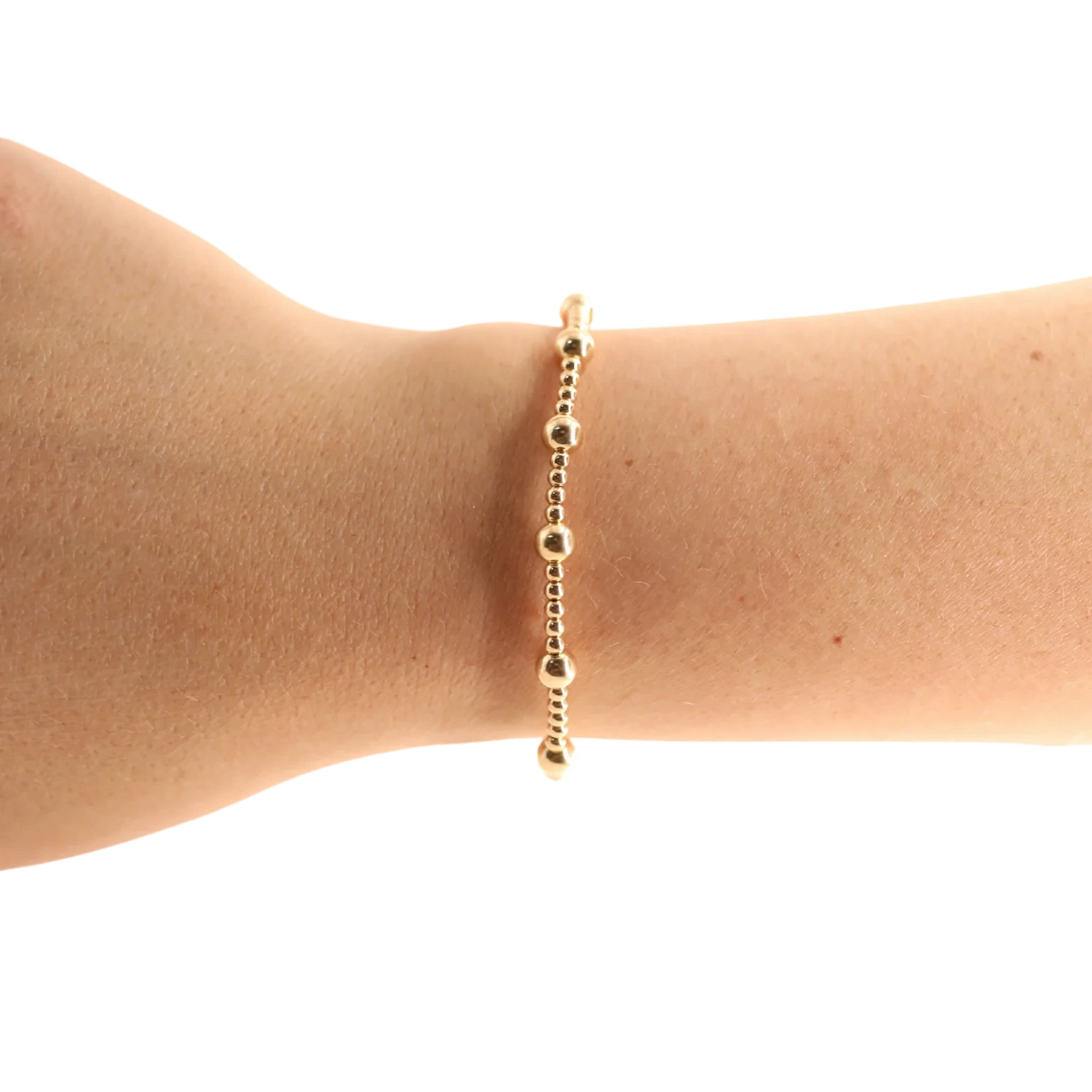 Beaded Blondes Lively Bracelet in Gold worn alone on a wrist.