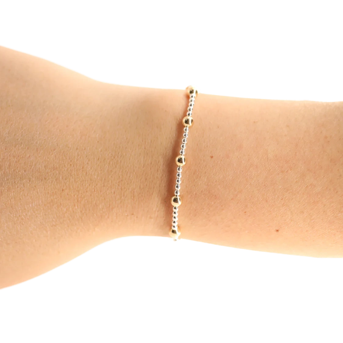 Beaded Blondes Lively Bracelet in Silver with Gold worn alone on a wrist against a white background.
