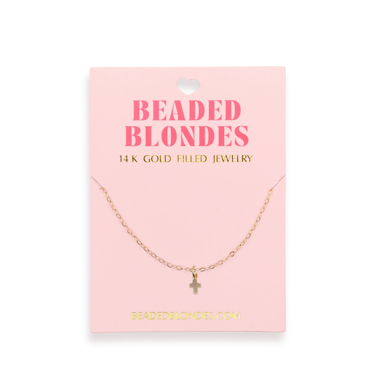 Beaded Blondes Mini Cross Charm Necklace displayed on a pink jewelry card.