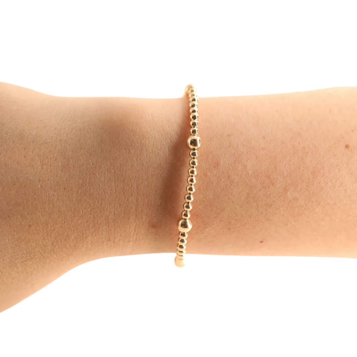 Beaded Blondes Olive Bracelet in Gold worn alone on a wrist against a white background.