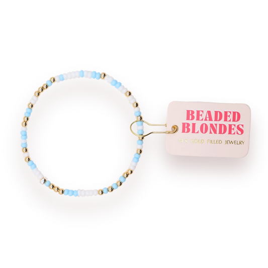 Beaded Blondes Powder Blue and White Sprinkle Bracelet beside a pink jewelry tag.