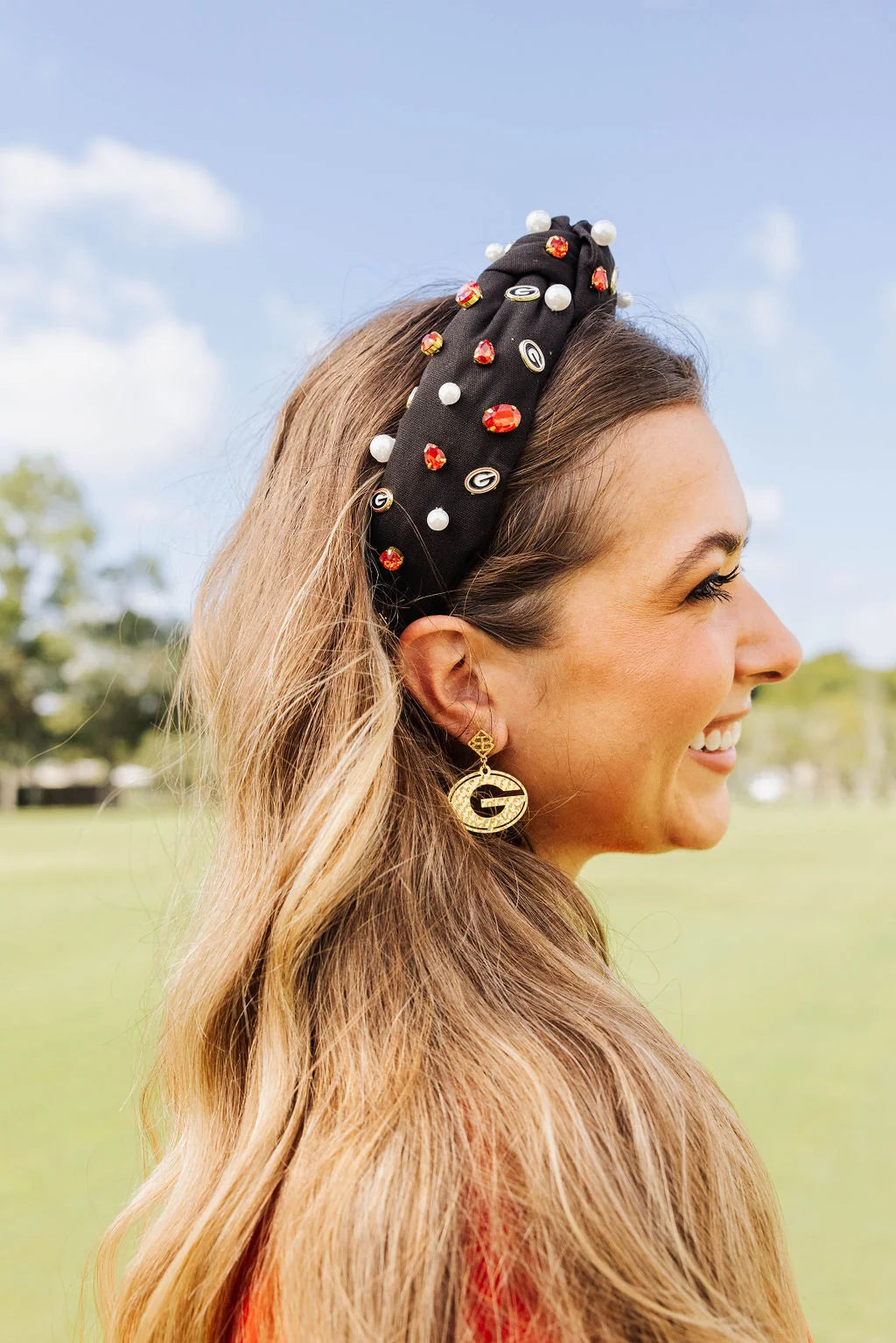 Woman wearing a decorative headband with colorful stones outdoors