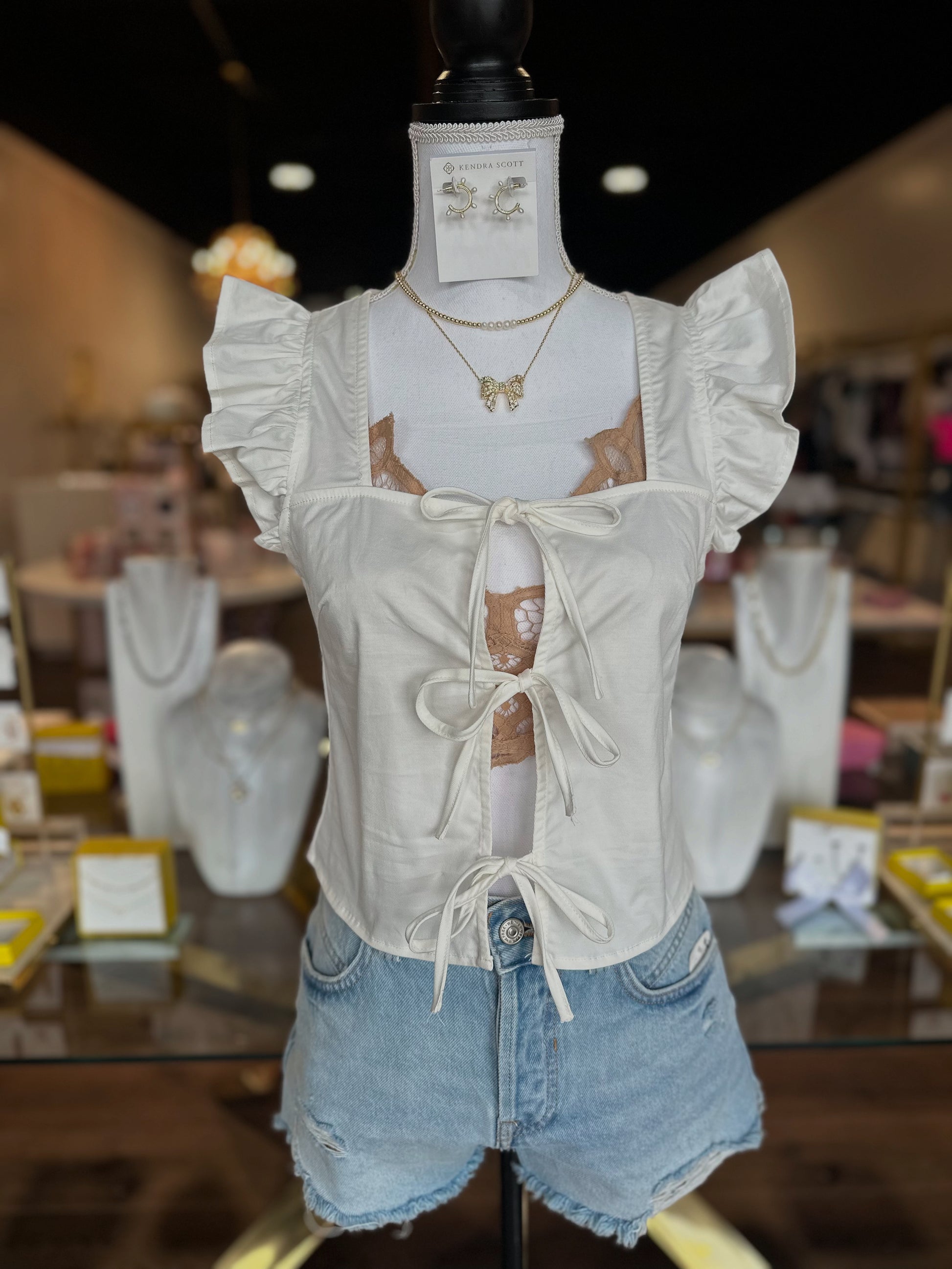 white tie top with denim shorts