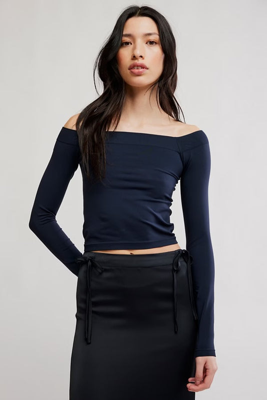 Model wearing black off the shoulder top  facing forwards