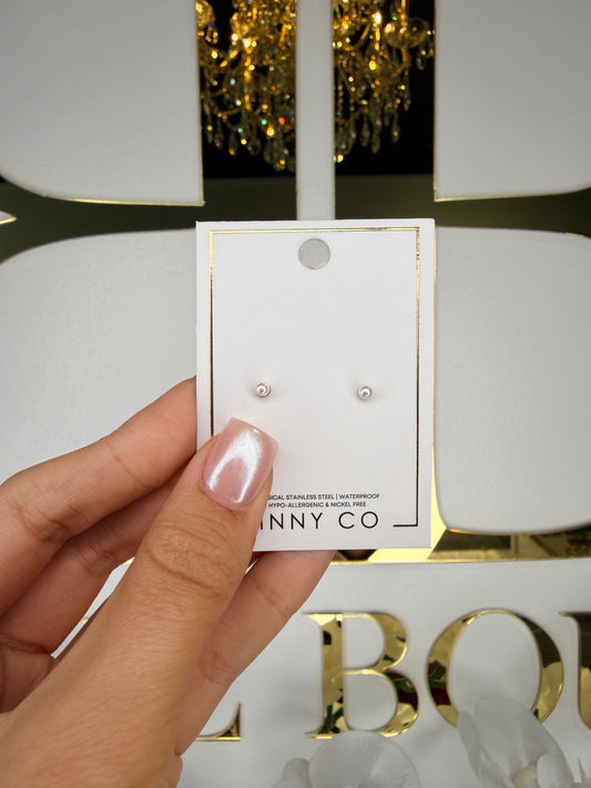 Hand holding a pair of earrings next to their packaging with 'Bunny & Co' branding.
