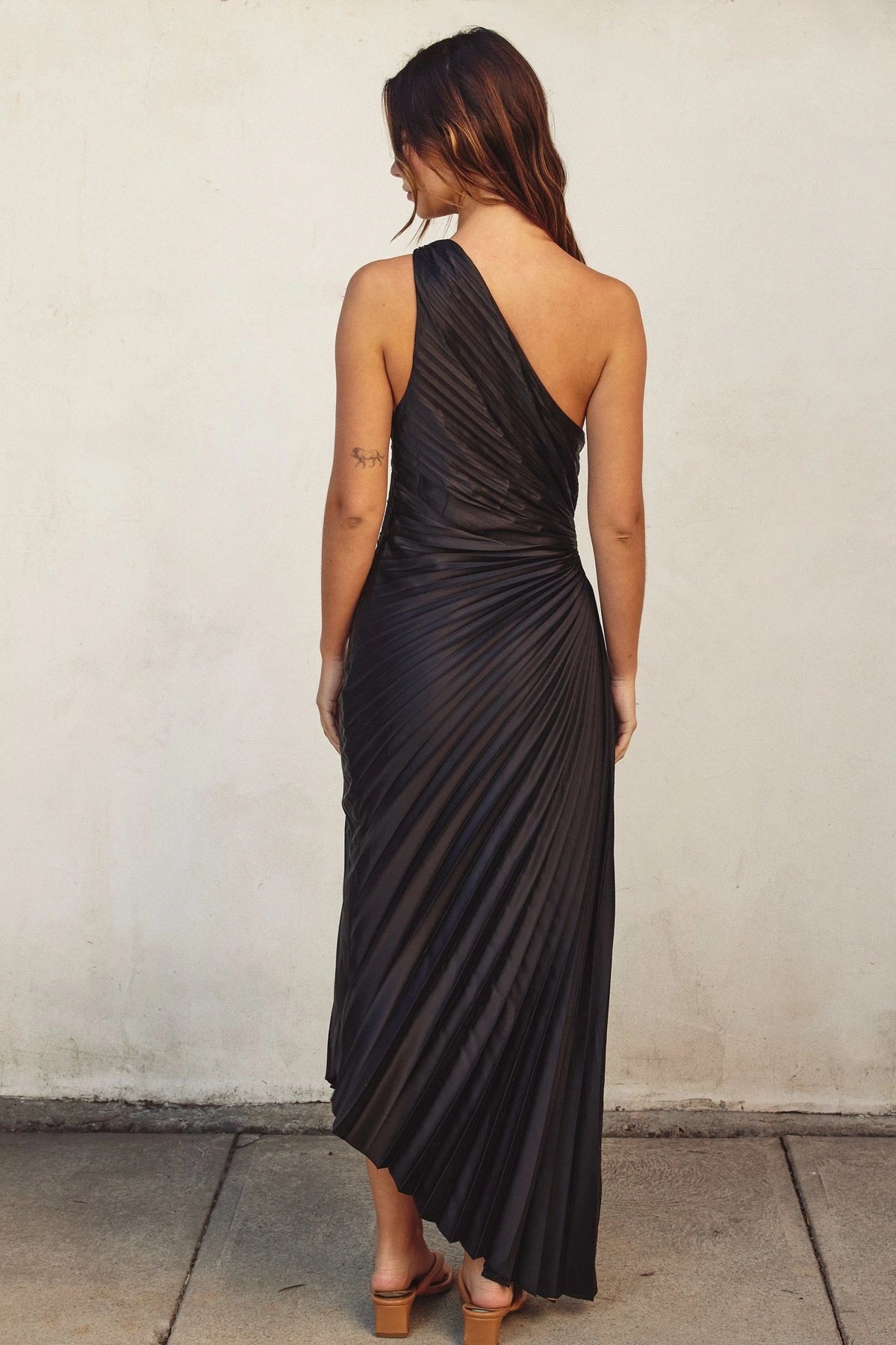 DRESS FORUM Olympia Asymmetrical Pleated Dress in Black, back view.