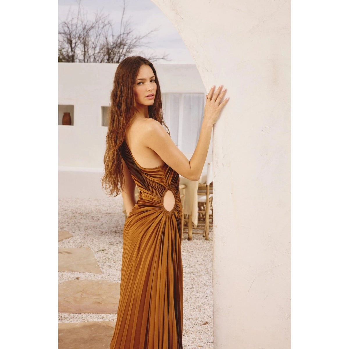 DRESS FORUM Olympia Asymmetrical Pleated Dress in Golden Ochre, side view.