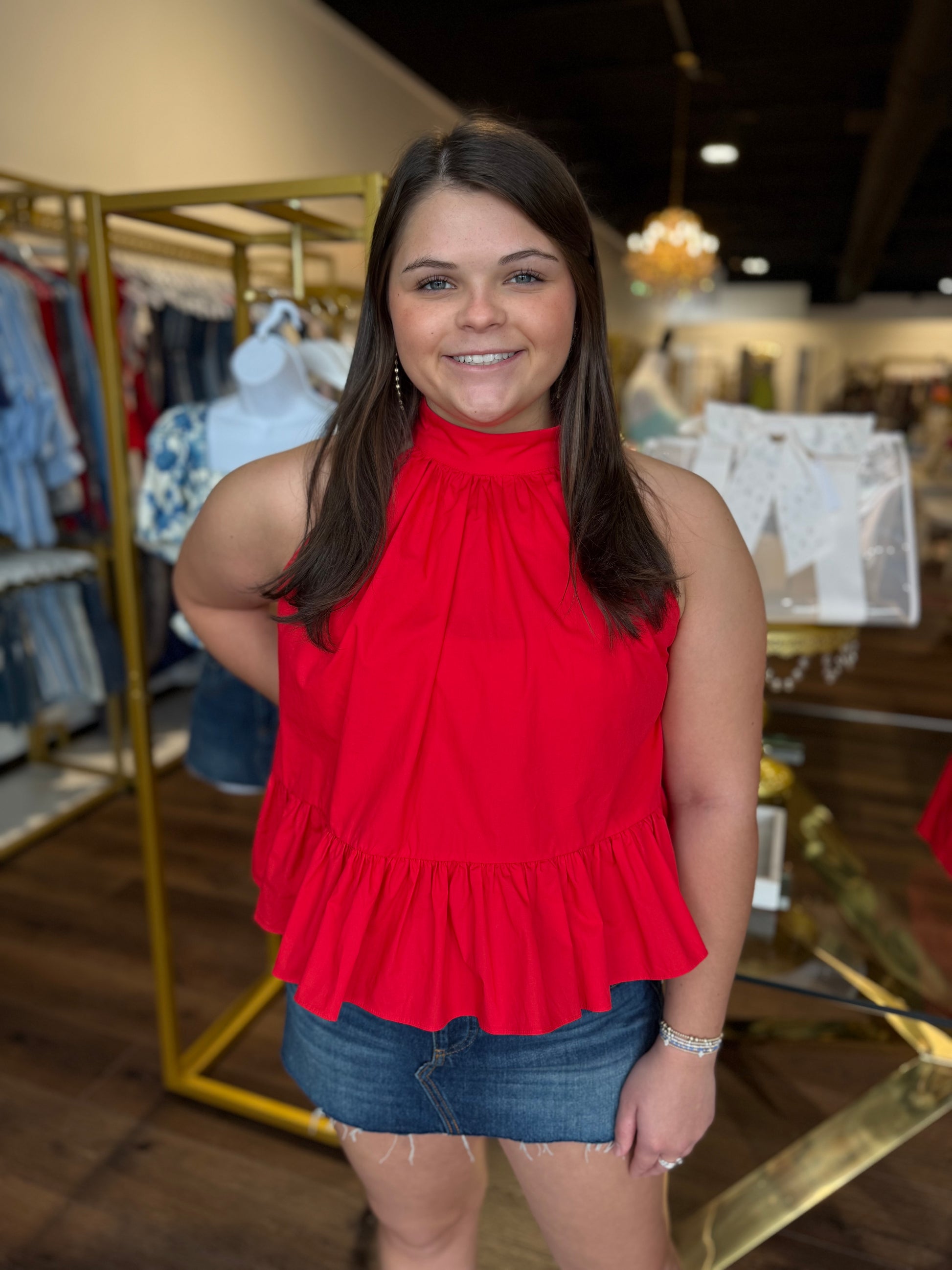Britique Boutique model wearing flowy red halter top with Free People Jean skirt in store