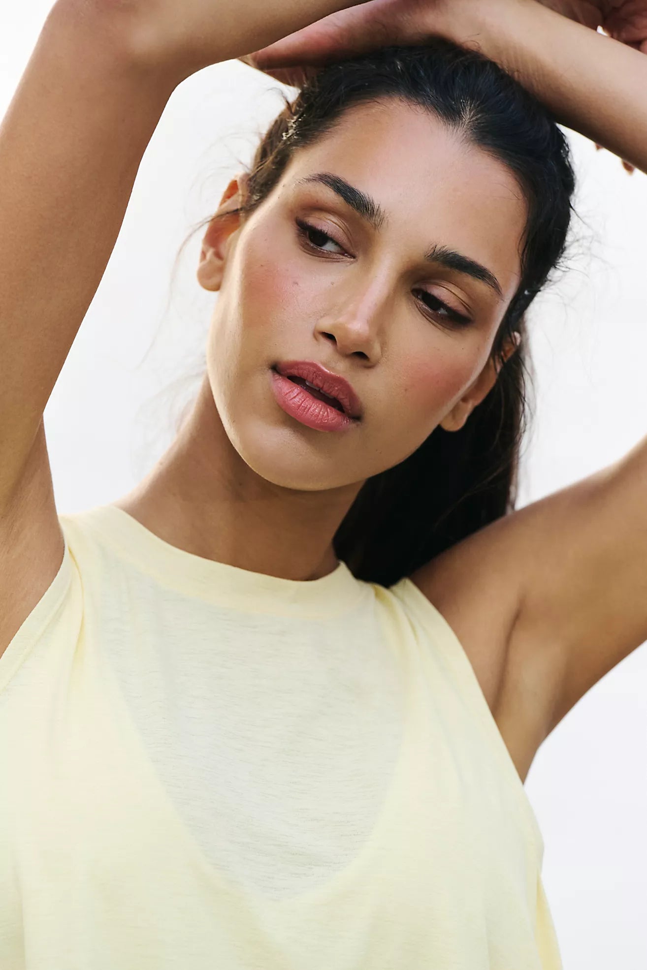 model close up wearing yellow tank
