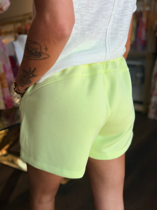 model wearing lime green shorts from the back