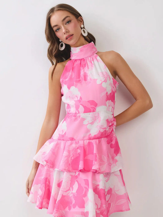 Woman wearing a pink floral dress against a white background