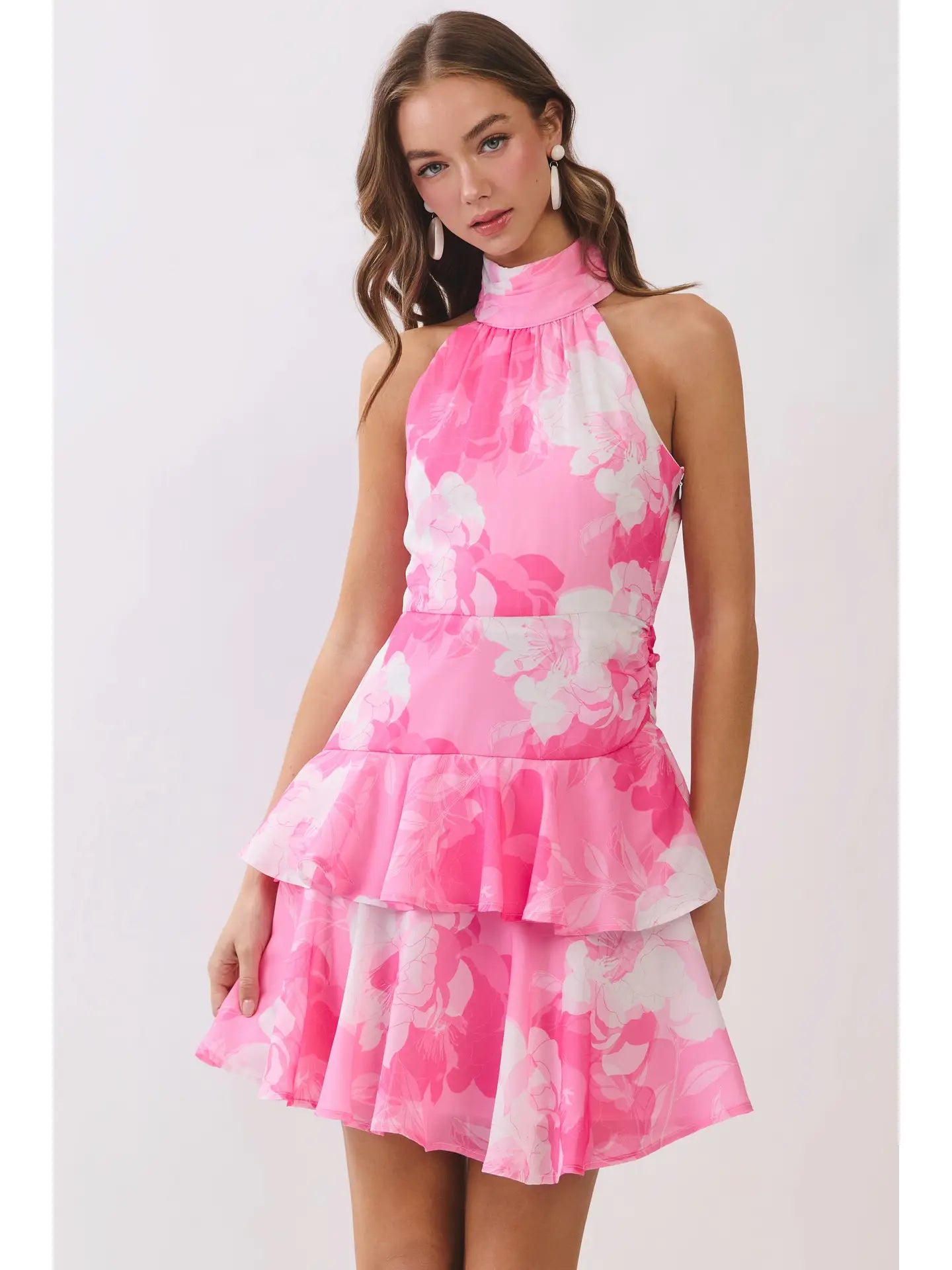 Woman wearing a pink floral dress on a white background