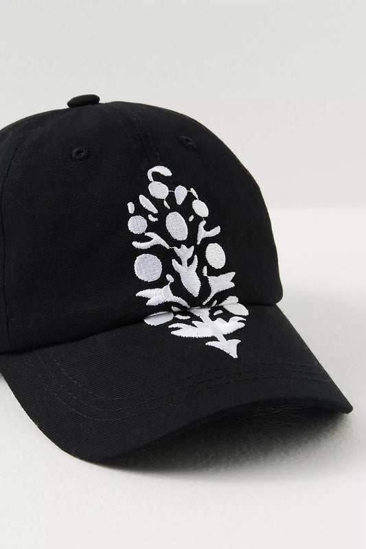 Free People Movement Big Buti Baseball Cap in Black / White, showing white floral embroidery.