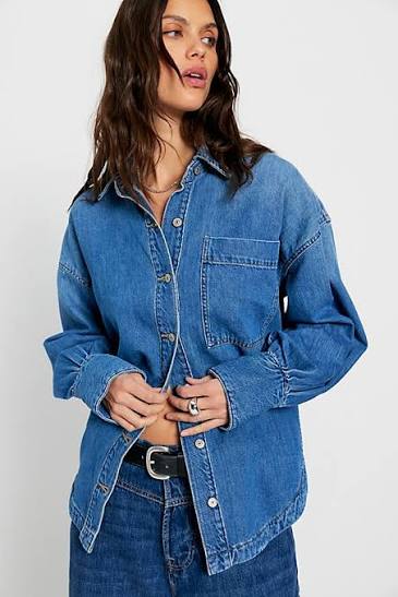 Woman wearing a blue denim shirt on a white background