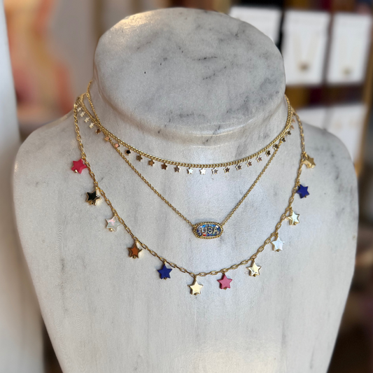 Necklace with colorful star pendants on a marble bust