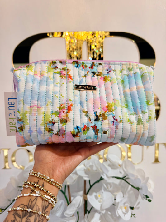 Laura park large cosmetic bag in multi color pattern infront of BB sign 