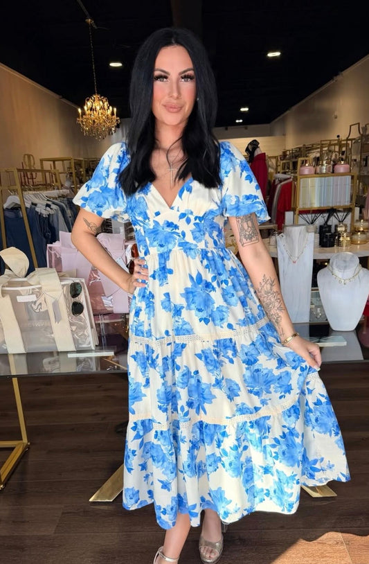 model wearing blue and white floral midi dress