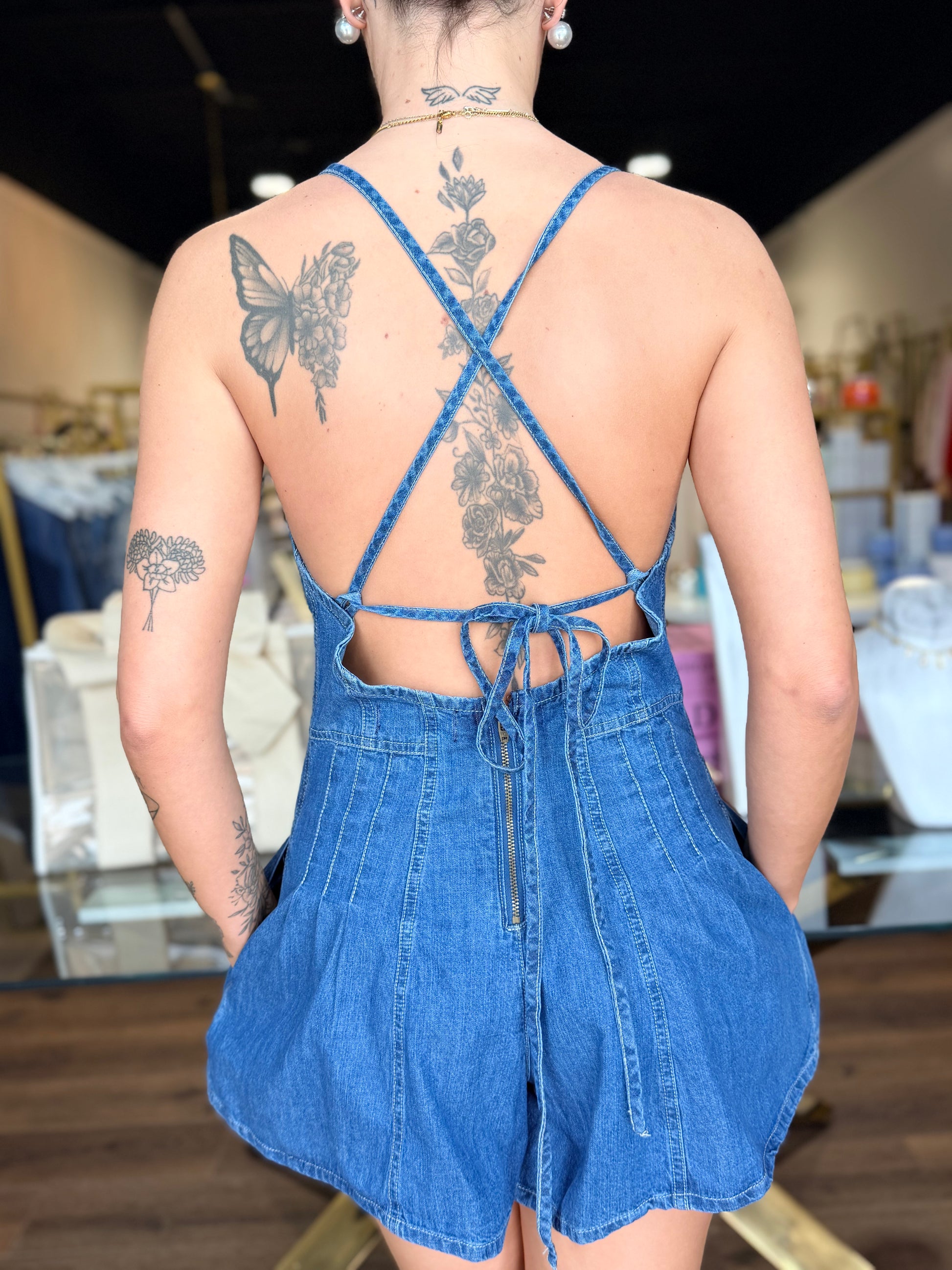 BRITIQUE BOUTIQUE MODEL IN FREE PEOPLE DENIM ROMPER BACK TIE VIEW