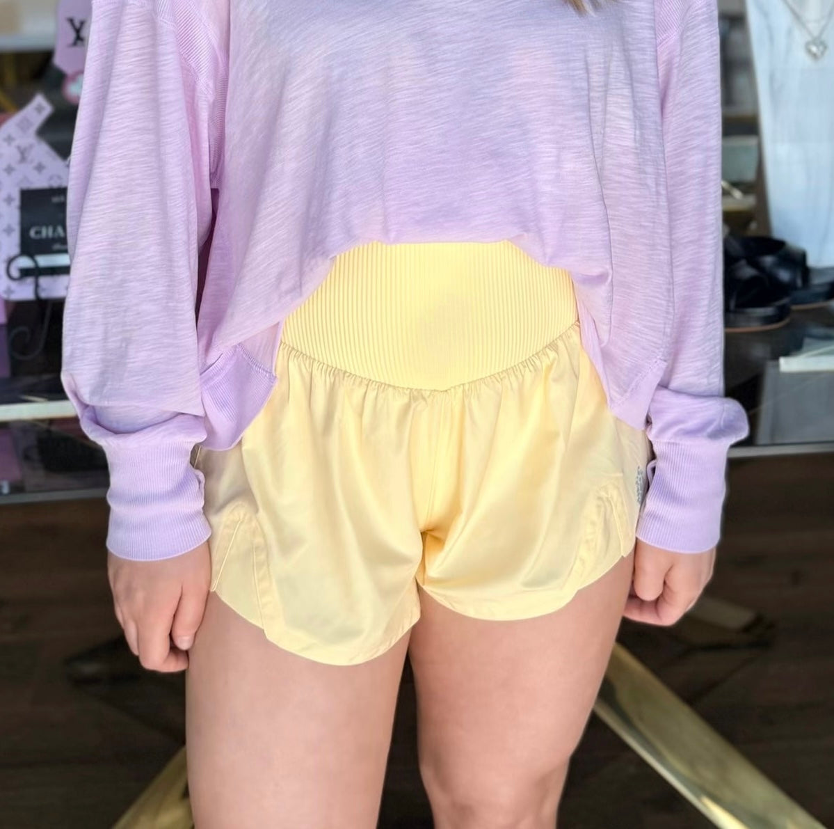 model wearing yellow athletic shorts