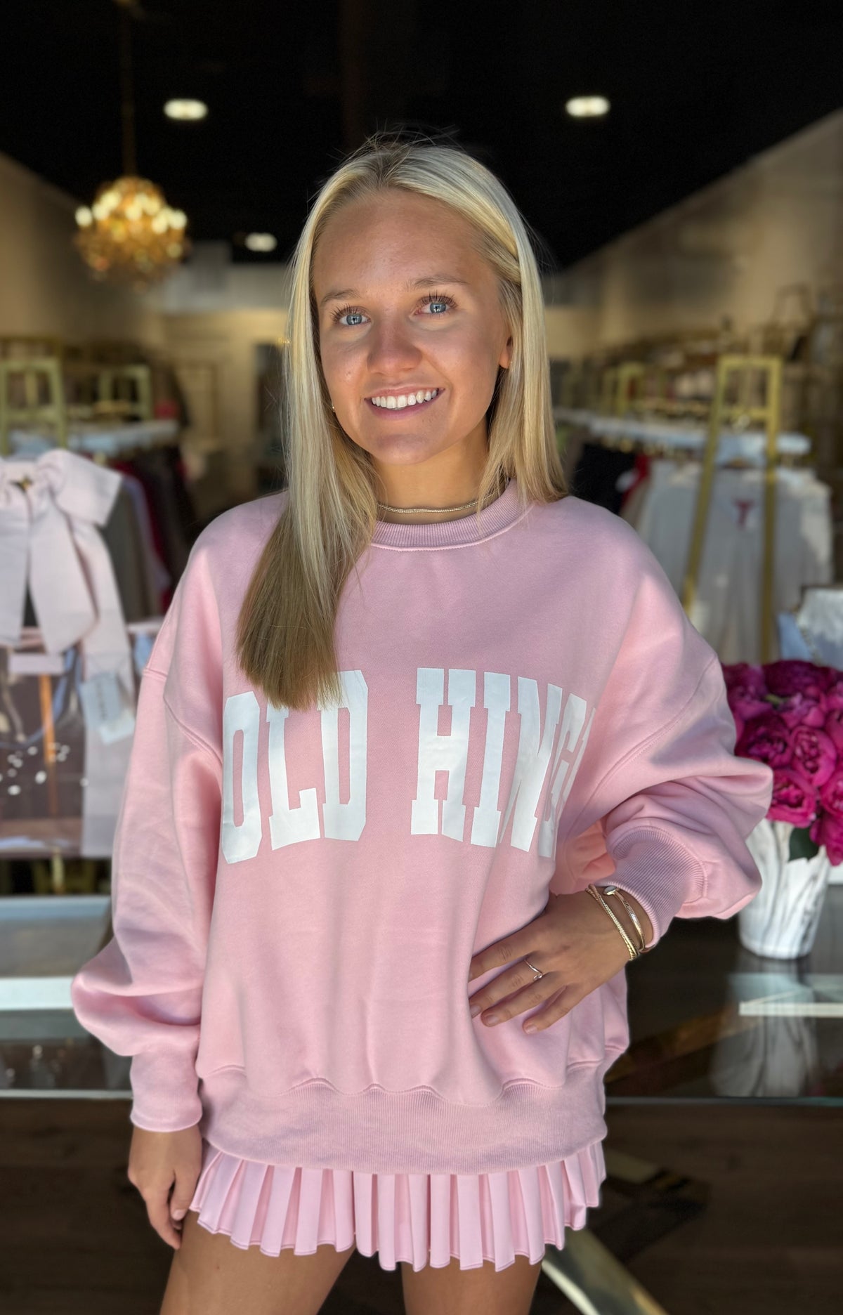 Gold Hinge Almond Blossom outfit featuring a pleated tennis skirt and GH wide arm sweatshirt