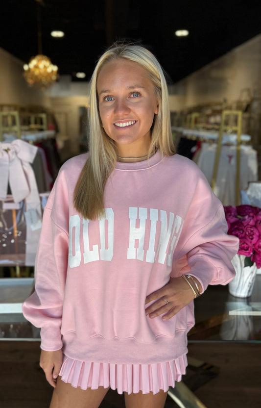 Gold Hinge Almond Blossom outfit featuring a pleated tennis skirt and GH wide arm sweatshirt
