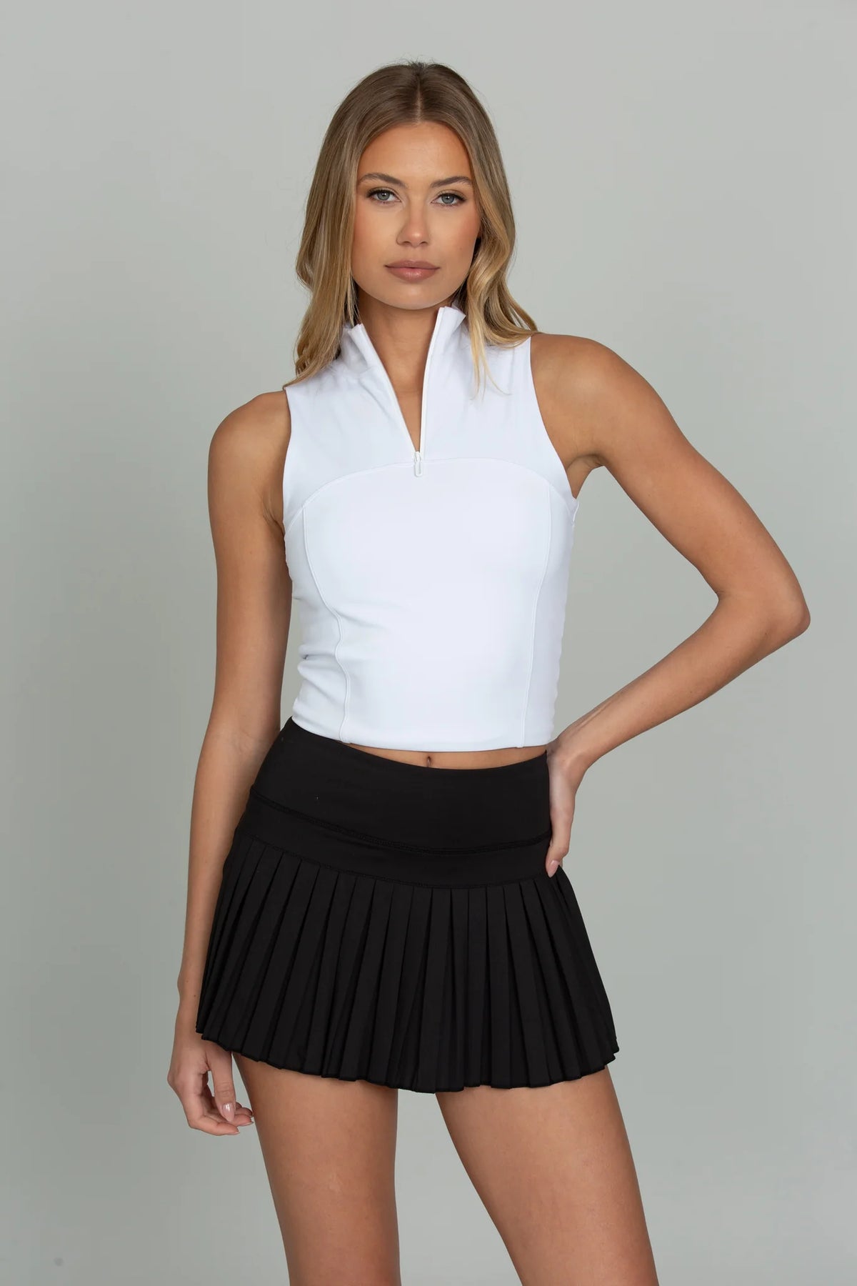 Full outfit featuring Gold Hinge Pleated Tennis Skirt in Black on model