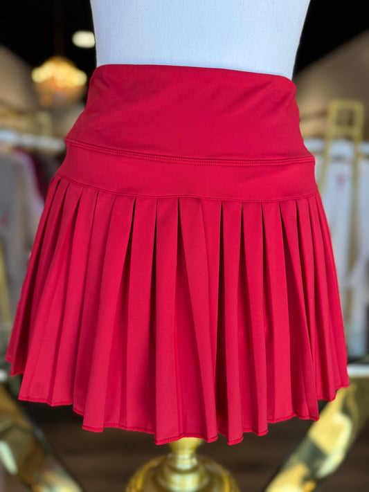 Gold Hinge pleated tennis skirt in Crimson, styled product photo